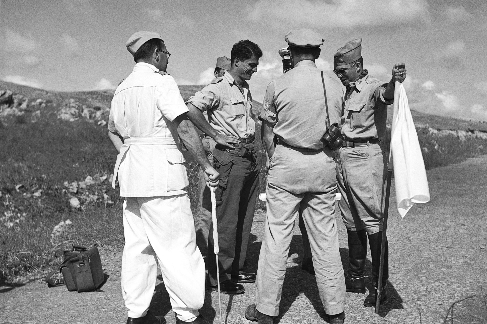 A group of military observers with the UN Truce Supervision Organization (UNTSO) confer in the no-man’s land between Merdya (Arab lines) and Nabi Yusha (Israeli lines) in January 1948. UN Photo/LM