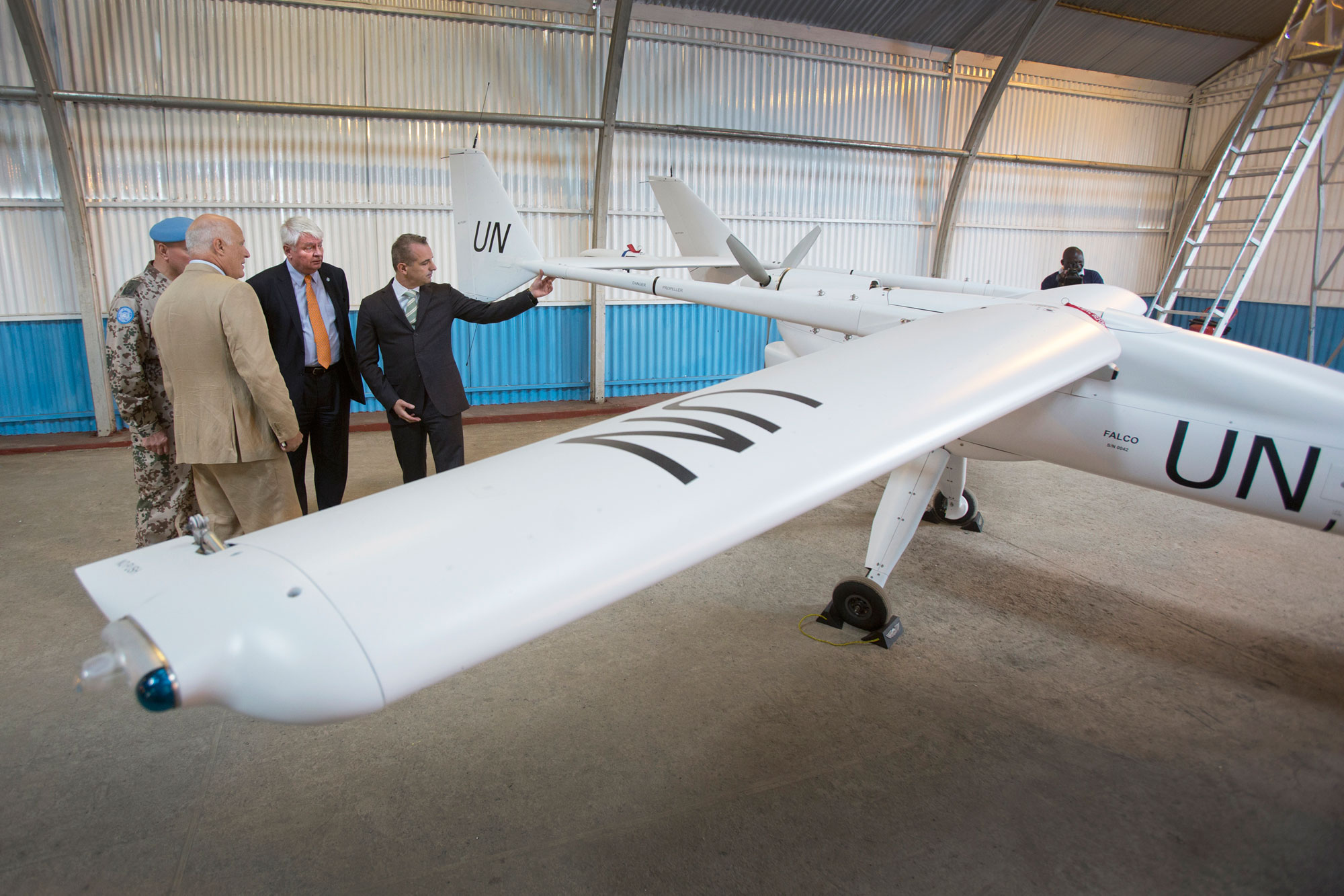 Under-Secretary-General Hervé Ladsous (second from right) is briefed on the unmanned aerial vehicles (UAVs) – used by the UN to enhance protection capabilities – before an official launch ceremony in Goma, Democratic Republic of the Congo, in December 2013. UN Photo/Sylvain Liechti