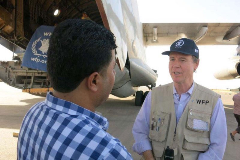 WFP Syria Country Director Jakob Kern speaks with a local journalist at Qamishly airport after the arrival of an airlift of WFP food and non-food items. The airlifts began on 9 July and the aim is to bring food for 150,000 people. Photo: WFP/Hiba Anty
