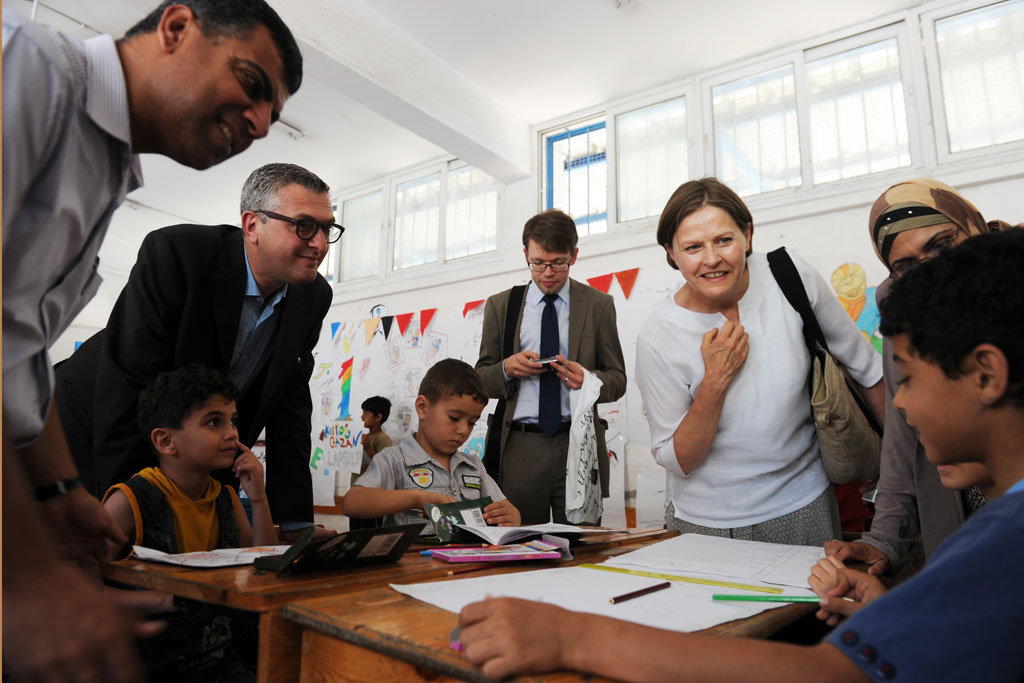 In June 2013, then UNRWA Commissioner-General Filippo Grandi (second from left) accompanies Heidi Hautala, Finnish Minister for International Development, during a visit to the Summer Fun Weeks programme in Gaza which provides activities such as football, kite flying and drawing for the territory’s children. UN Photo/Shareef Sarhan