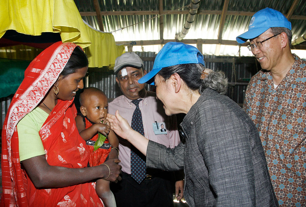 Yoo Soon-taek, wife of Secretary-General Ban Ki-moon (right), meets with one of the victims of the recent floods in Sirajganj at the Disaster Management Centre sponsored by the Government of Bangladesh. (November 2009) UN Photo/Mark Garten
