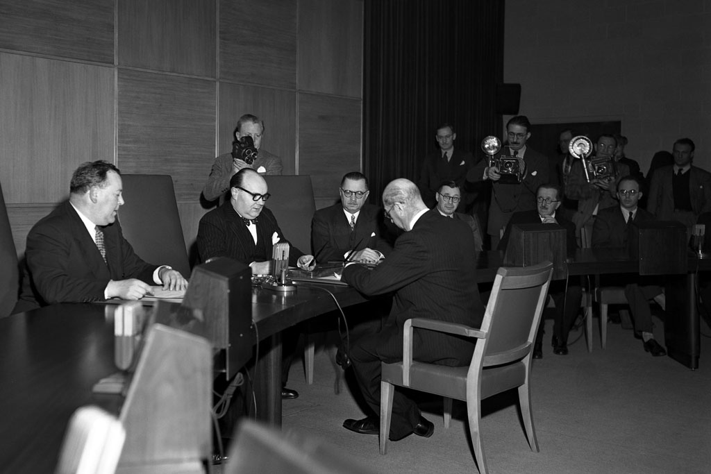 19 November 1946 – Afghanistan’s linkages to the United Nations began in 1946, when the country became a member of the world body. Shown here, at the UN’s temporary headquarters at Flushing Meadows in New York, the Afghan representative to the United States, A. Hosayn Aziz, signs – on behalf of his government – the ‘instrument of adherence’ to the UN Charter during the country’s admission ceremony to membership in the United Nations. Those sitting in front of the ambassador include (from left) Secretary-General Trygve Lie and the President of the General Assembly at that time, Paul-Henri Spaak. UN Photo