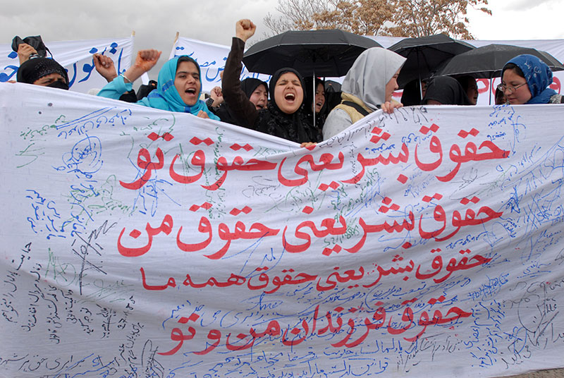 Women demonstrating for rights. The banner reads: “Human rights are your rights! Human rights are my right! Human rights are our rights!” Photo: Farzana Wahidy