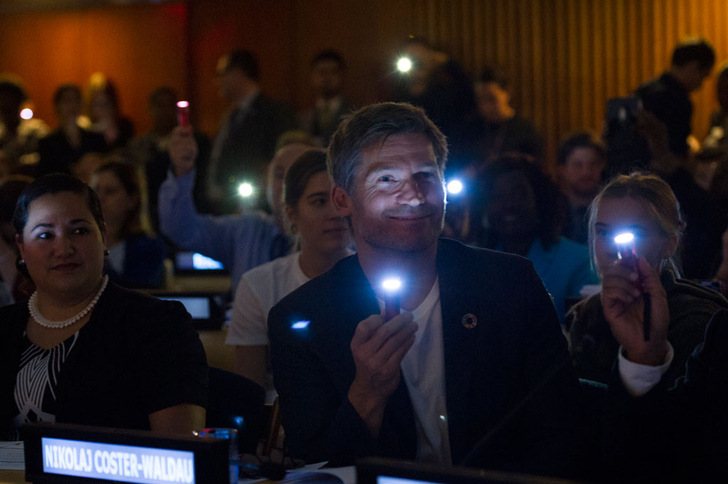 The high-level week saw UN officials, governments, civil society and celebrities rally around a number of initiatives, including on financing education for all, advancing the Sustainable Development Goals and promoting maternal and child health. Seen here is actor and UN Development Programme Goodwill Ambassador Nikolaj Coster-Waldau shining a light along with other attendees at the launch of the EU-UN Spotlight Initiative for the elimination of violence against women and girls. UN Photo/Rick Bajornas