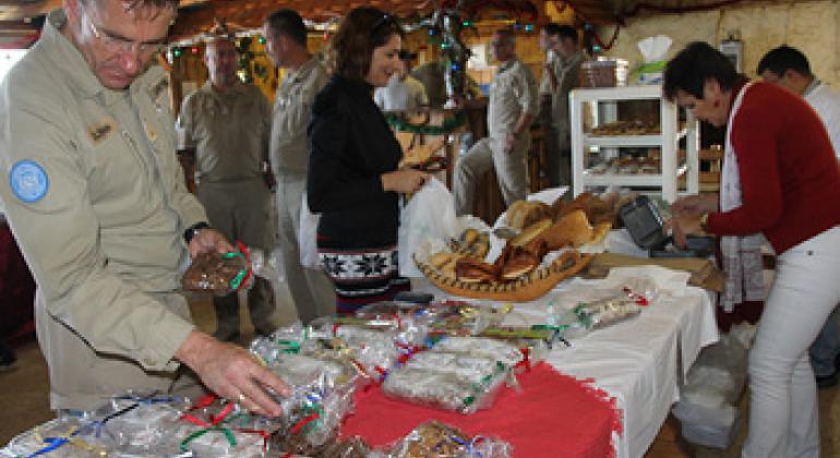 Austrian Peacekeeper checking sweets made by Mosan Center during a Christmas celebration organized in UNIFIL Headquarters in Naqoura South Lebanon. UNIFIL@PHOTO