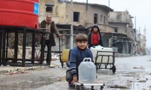 In east Aleppo City, Syria, boys and a man collect water from a UNICEF-supported water point in Shakoor neighbourhood.