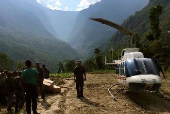 A Nepalese military helicopter delivers relief supplies to Ladhu village in Sindhulpalchok district.
