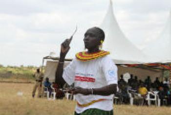 A woman holds a knife used in FGM.